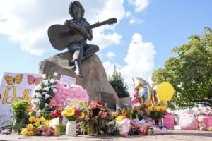 Flowers, butterflies and handwritten notes left at the Dolly Parton statue in Sevierville, Tennessee